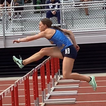 Sasquatch track a field team member, Miranda Irwin, clearing hurdles at the 2023 heptathlon competition. 