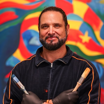 Portrait of muralist Michael Che Romero