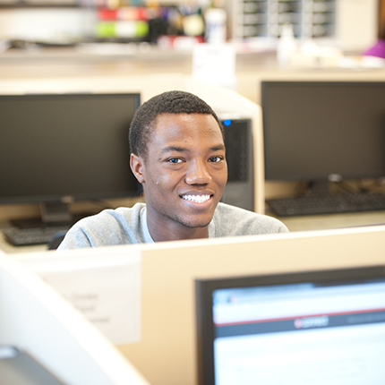 Male sitting at a computer.