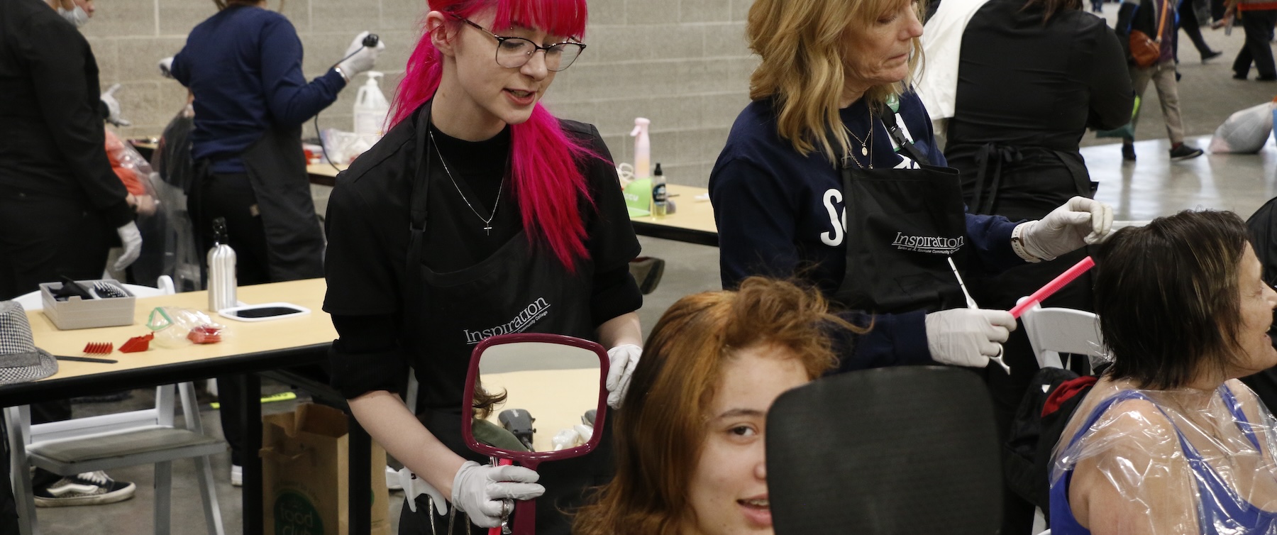 Cheyenne cuts the hair of her client Savannah