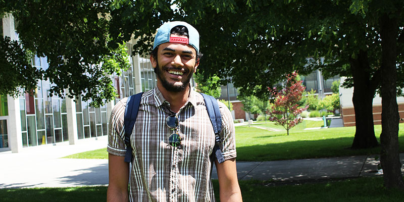 Smiling young man outside music building