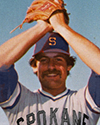 smiling player holds his mitt above his head
