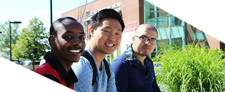 international students standing on the stairs outside the arts building at SFCC