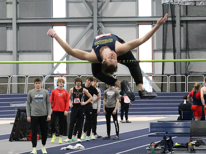 CCS teammate performs the high jump as other teams watch