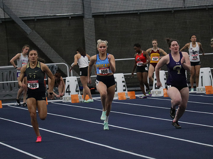 Three runner racing for best time at Whitworth Indoor Invitational