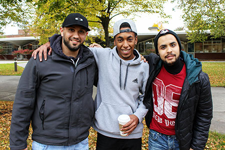 Smiling group of male students outdoors